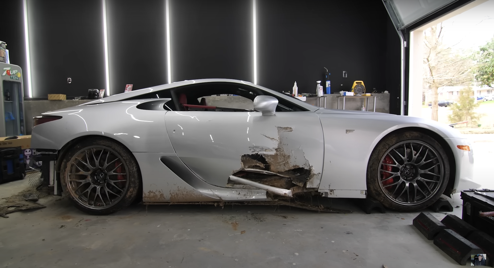 Crashed Lexus LFA showing damage to right-hand door